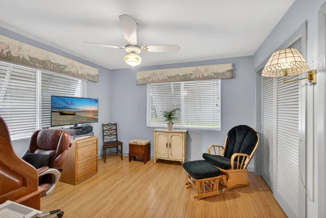 a view of a patio with a table and chairs under an umbrella
