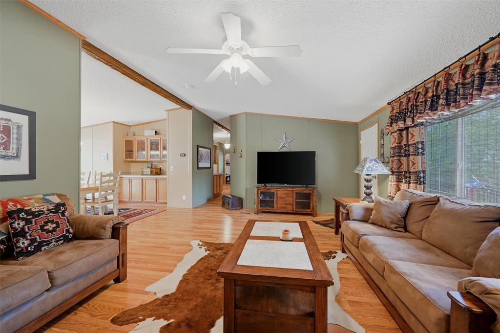 212 Sunset Road Pottsboro, TX 75076 - Photo 6 of 40 a living room with furniture and a flat screen tv