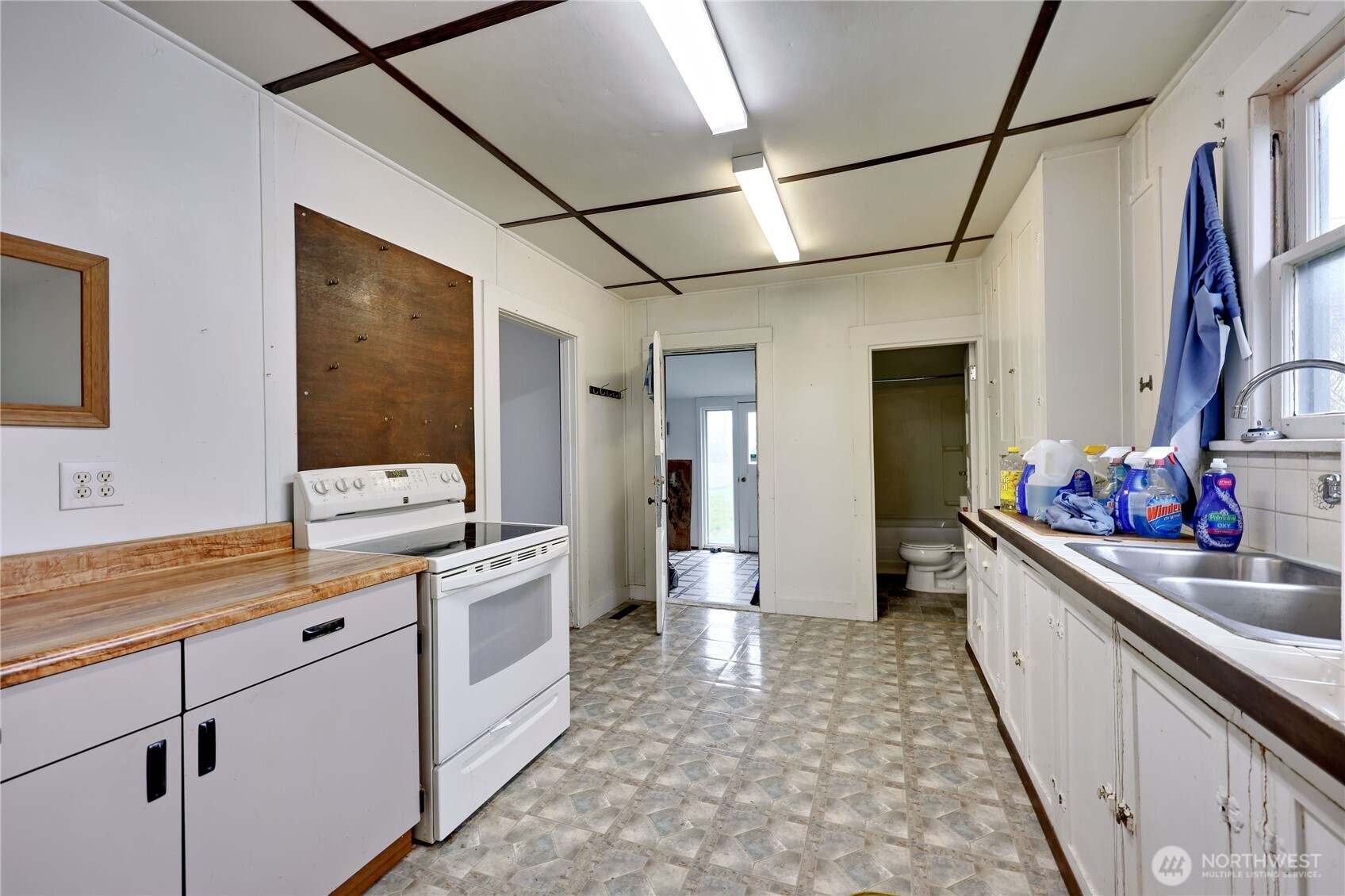 514 Shore Drive Bremerton, WA 98310 - Photo 14 of 40 a kitchen with a sink and white cabinets