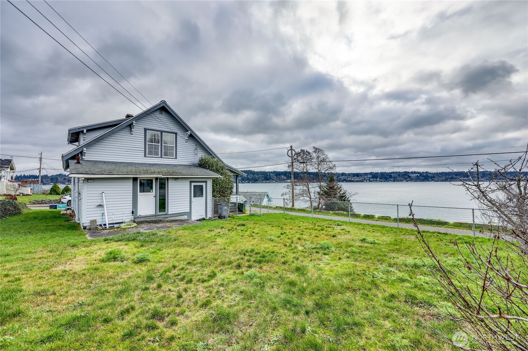 514 Shore Drive Bremerton, WA 98310 - Photo 5 of 40 a view of a house with a big yard and large trees