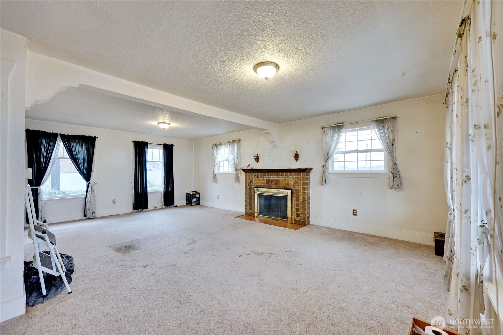 514 Shore Drive Bremerton, WA 98310 - Photo 10 of 40 a view of a livingroom with a fireplace and window