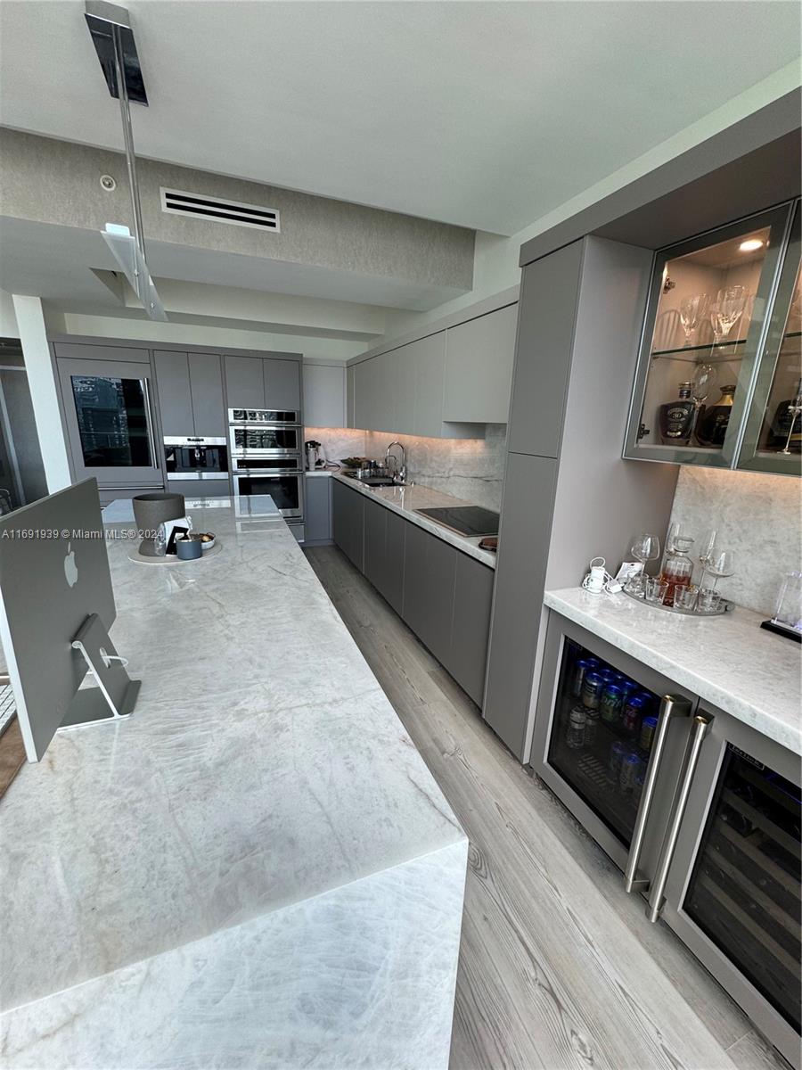 90 Southwest 3rd Street, Unit PH15 Miami, FL 33130 - Photo 12 of 18 a kitchen with sink stove and cabinets