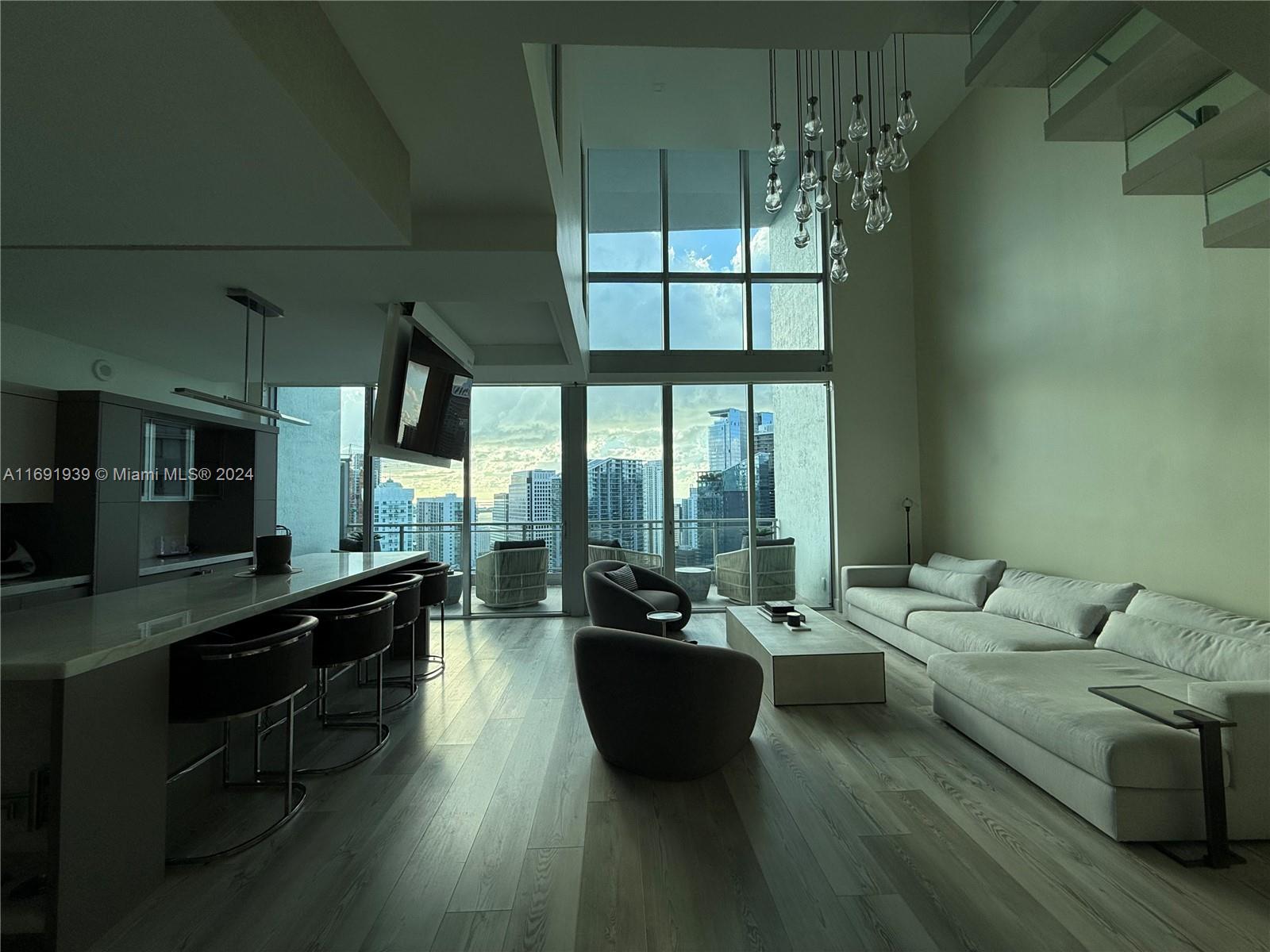 90 Southwest 3rd Street, Unit PH15 Miami, FL 33130 - Photo 15 of 18 a living room with furniture and a flat screen tv