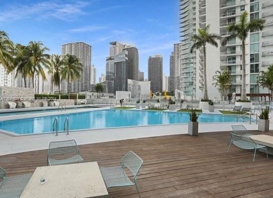 90 Southwest 3rd Street, Unit PH15 Miami, FL 33130 - Photo 2 of 18 a view of a swimming pool with outdoor seating
