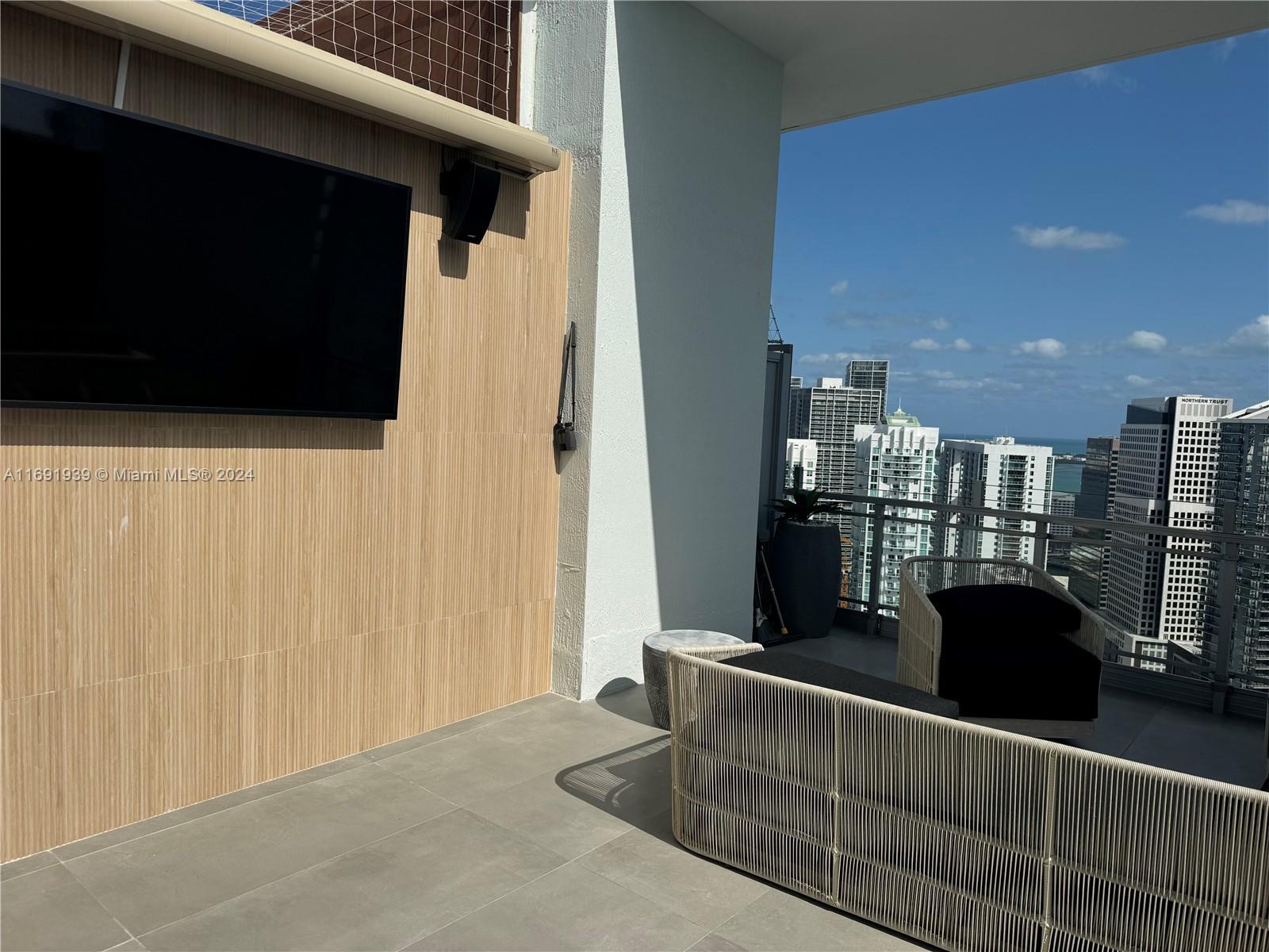 90 Southwest 3rd Street, Unit PH15 Miami, FL 33130 - Photo 5 of 18 a living room with furniture and a flat screen tv
