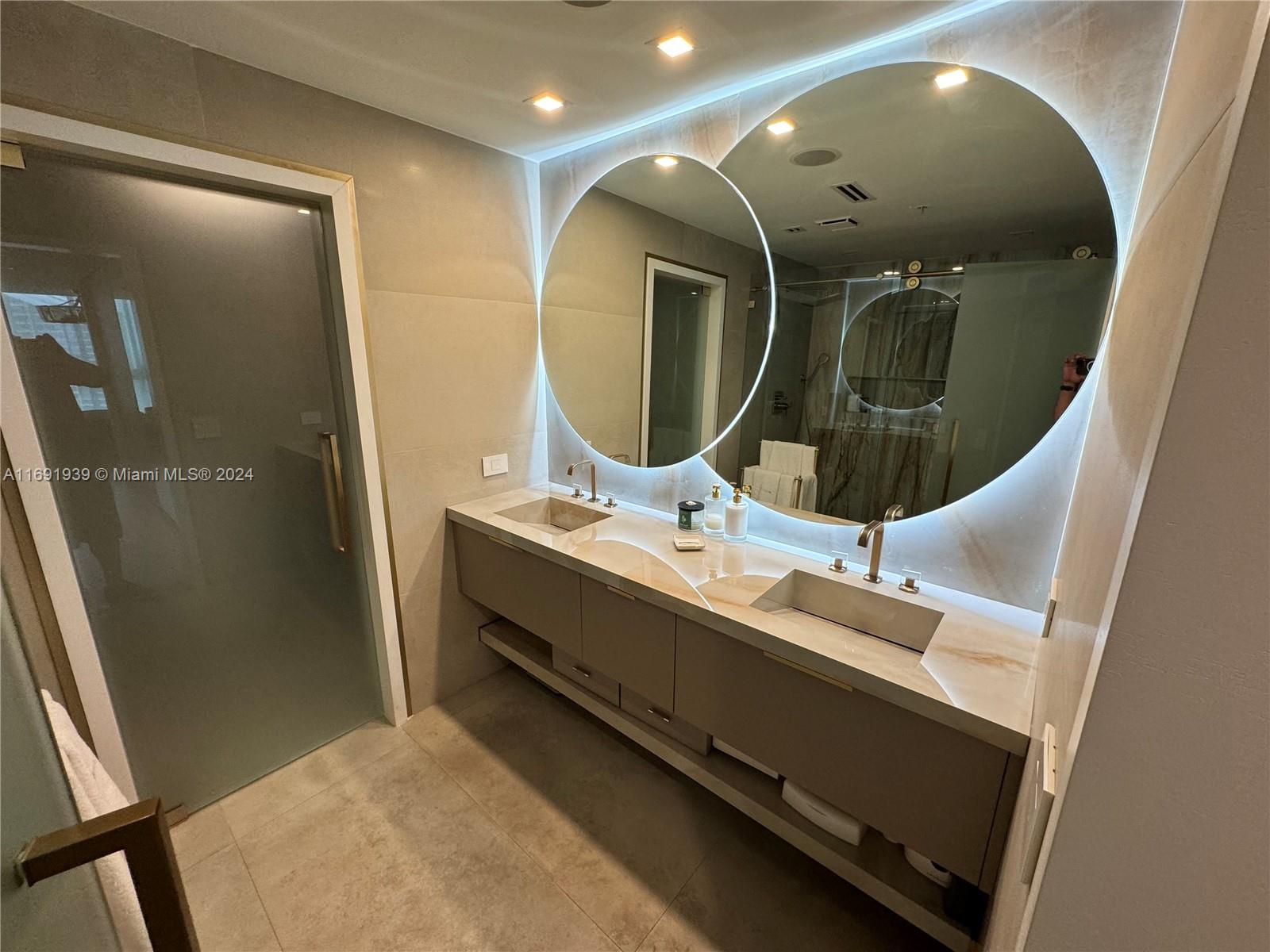 90 Southwest 3rd Street, Unit PH15 Miami, FL 33130 - Photo 9 of 18 a bathroom with a double vanity sink and a mirror