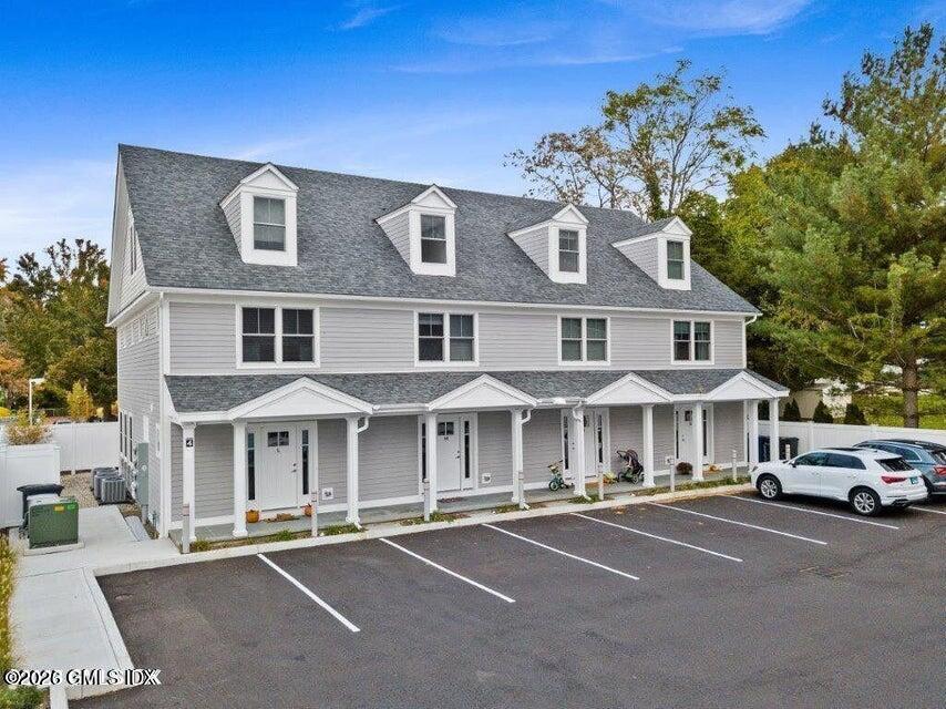 a front view of a residential apartment building with a yard