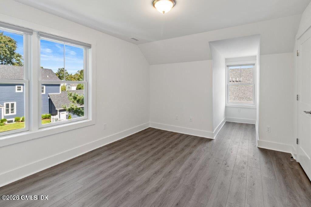 4 Orchard Street, Unit M Cos Cob, CT 06807 - Photo 12 of 19 an empty room with wooden floor and windows