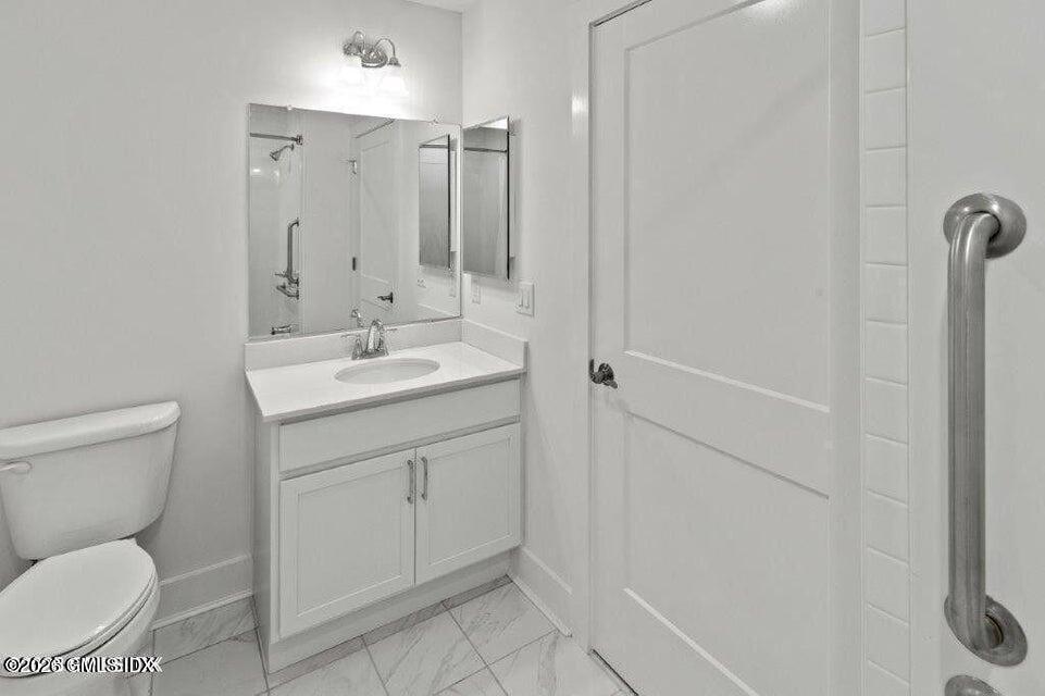 4 Orchard Street, Unit M Cos Cob, CT 06807 - Photo 13 of 19 a bathroom with a toilet sink and mirror