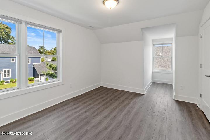 4 Orchard Street, Unit M Cos Cob, CT 06807 - Photo 10 of 19 an empty room with wooden floor and windows