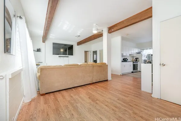 a living room with furniture and a wooden floor