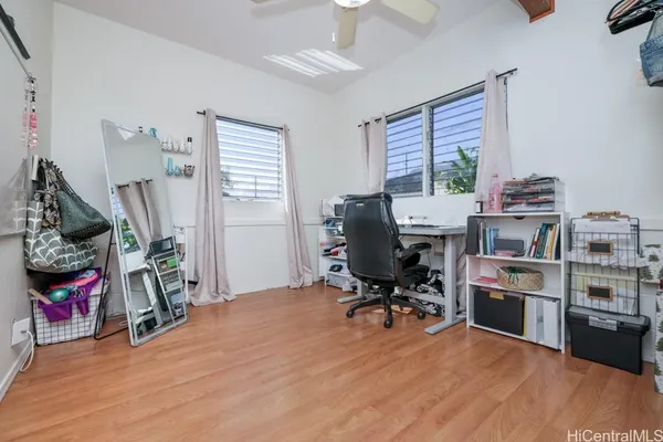 a view of a workspace with furniture and a window