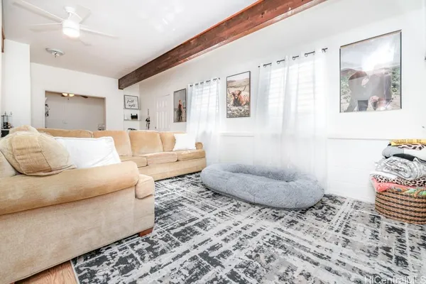 a living room with furniture and a painting on the wall