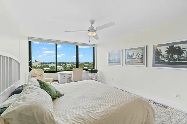 a large bedroom with a large bed and a large window