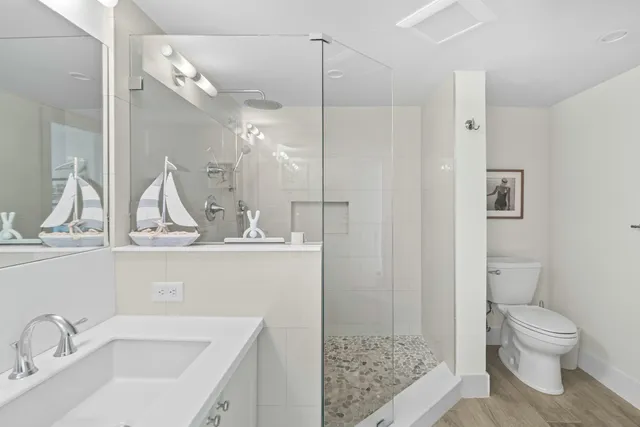 a bathroom with a toilet sink and shower