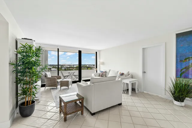 a living room with furniture and a potted plant