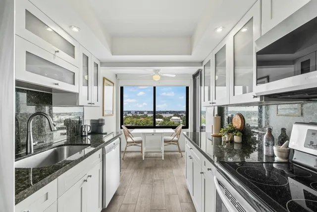 a kitchen with granite countertop a sink and cabinets