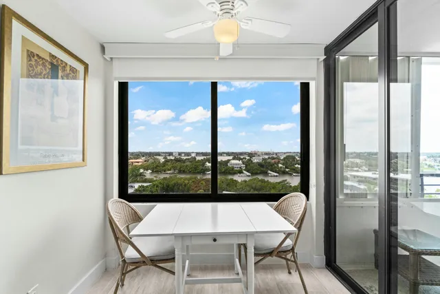 a view of a dining room with furniture a chandelier and wooden floor