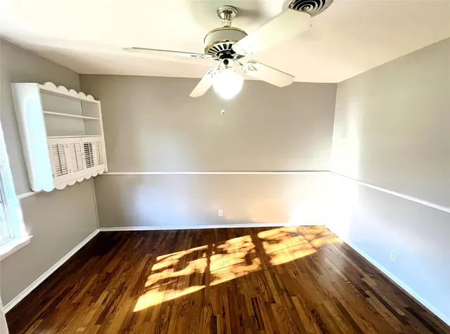 a view of a room with wooden floor