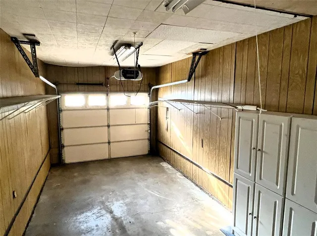 a view of a house with backyard and a tree