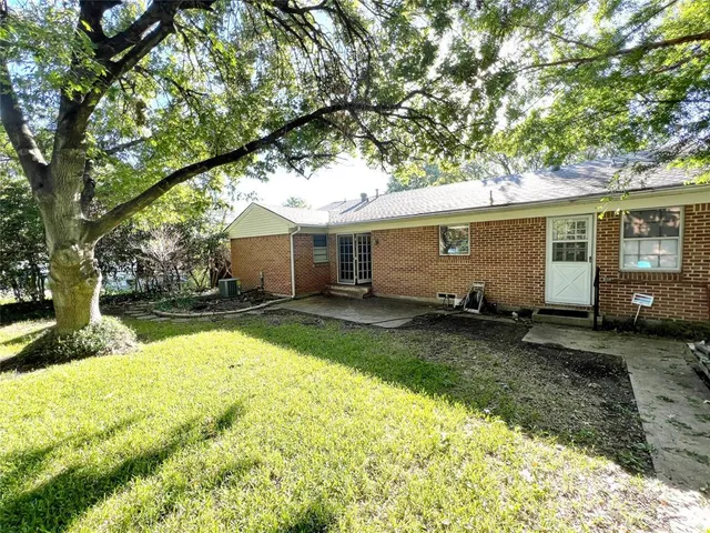 a view of a yard with plants and trees