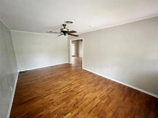 a view of a room with wooden floor