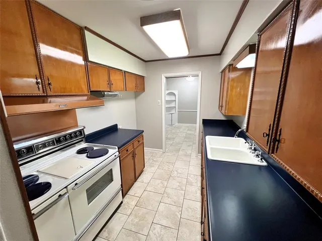 a kitchen with a stove and a sink