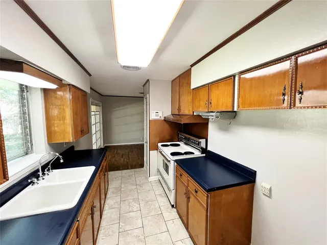 a kitchen with a sink stove and cabinets