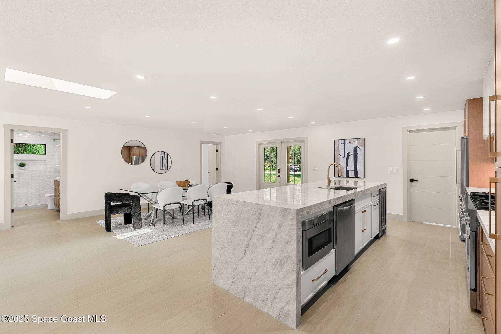 4313 Country Road Melbourne, FL 32934 - Photo 16 of 58 a large kitchen with stainless steel appliances granite countertop a stove and a refrigerator