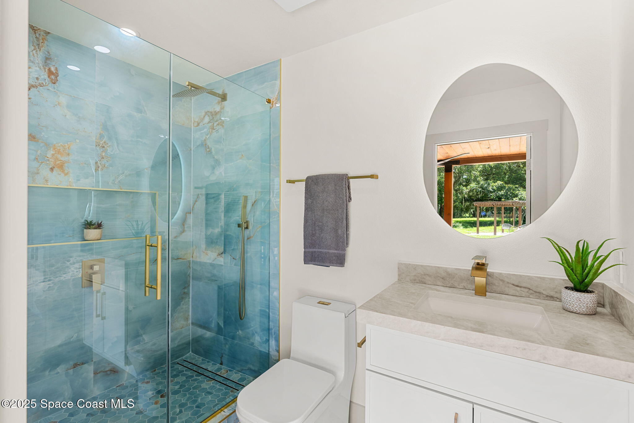 4313 Country Road Melbourne, FL 32934 - Photo 20 of 58 a bathroom with a sink a toilet and a shower