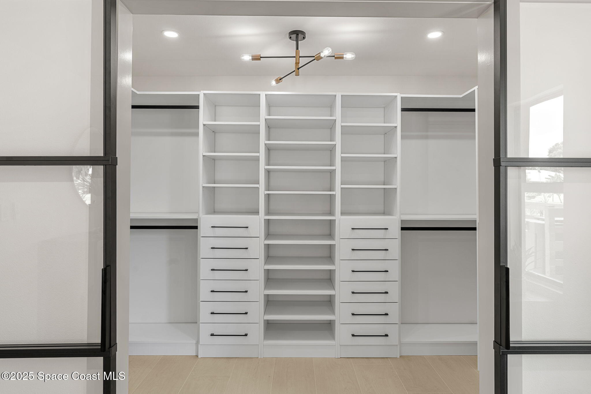 4313 Country Road Melbourne, FL 32934 - Photo 24 of 58 a view of walk in closet with empty racks