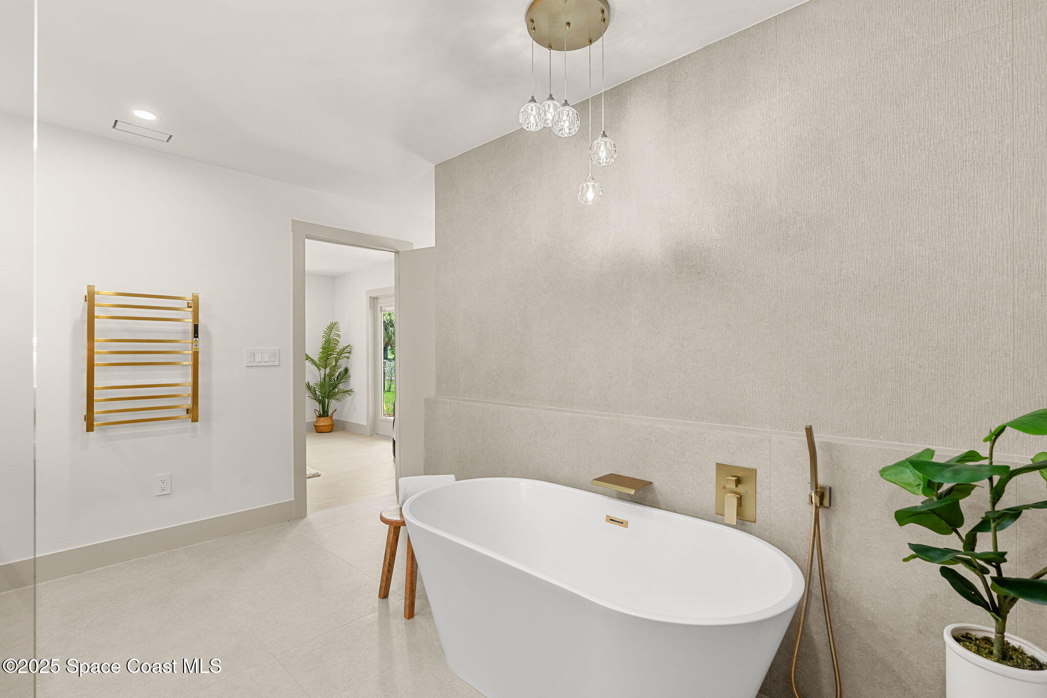 4313 Country Road Melbourne, FL 32934 - Photo 26 of 58 a bathroom with a bathtub a sink a toilet and a window