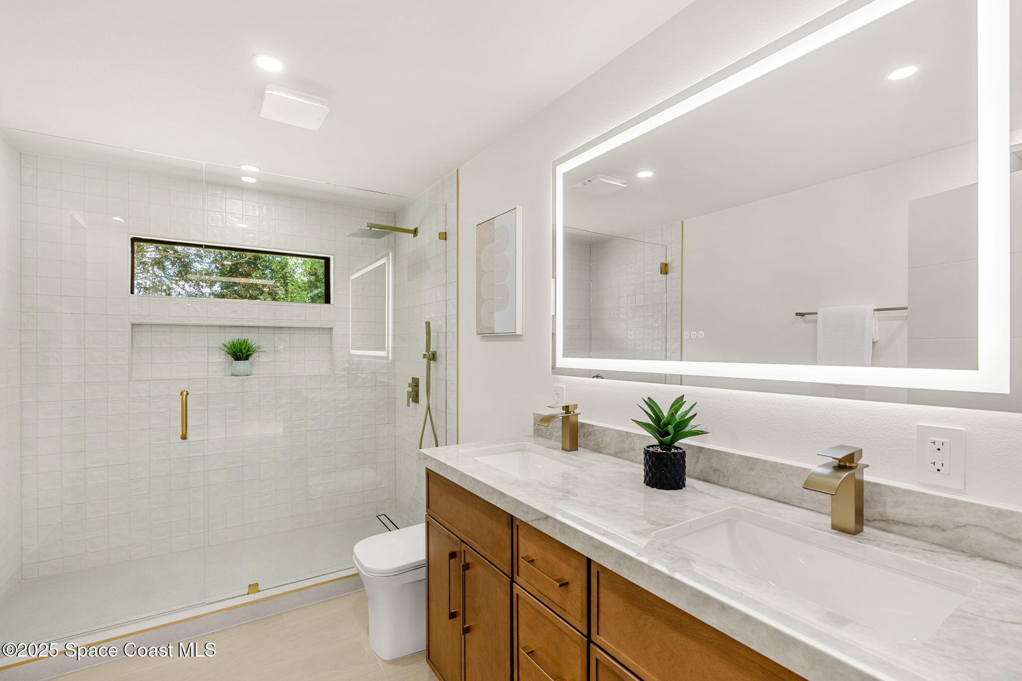 4313 Country Road Melbourne, FL 32934 - Photo 27 of 58 a bathroom with a granite countertop sink a toilet and a shower