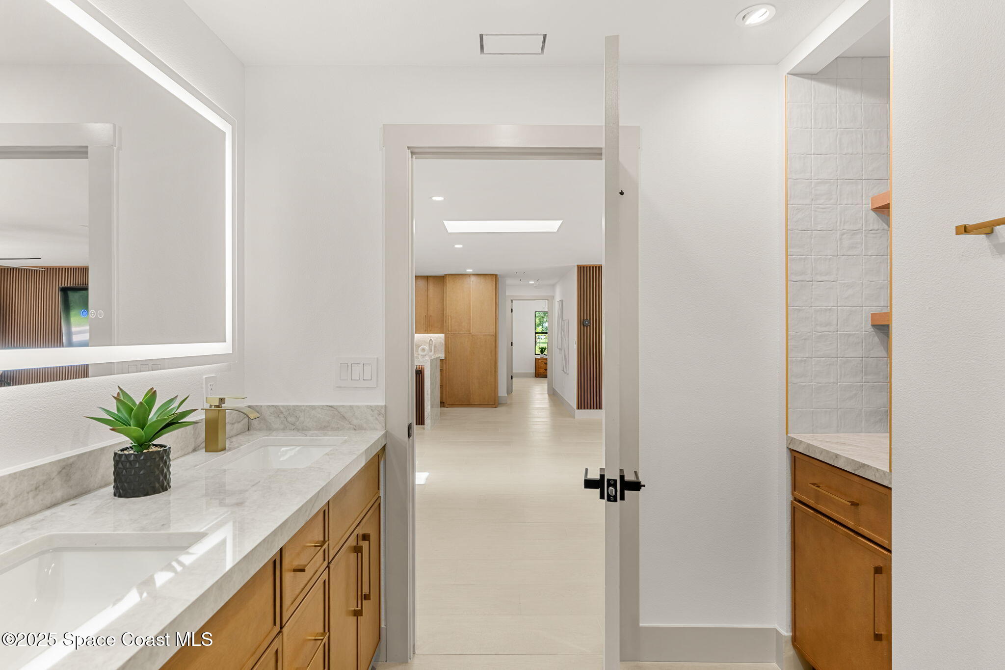 4313 Country Road Melbourne, FL 32934 - Photo 28 of 58 a bathroom with a granite countertop sink a mirror and a shower