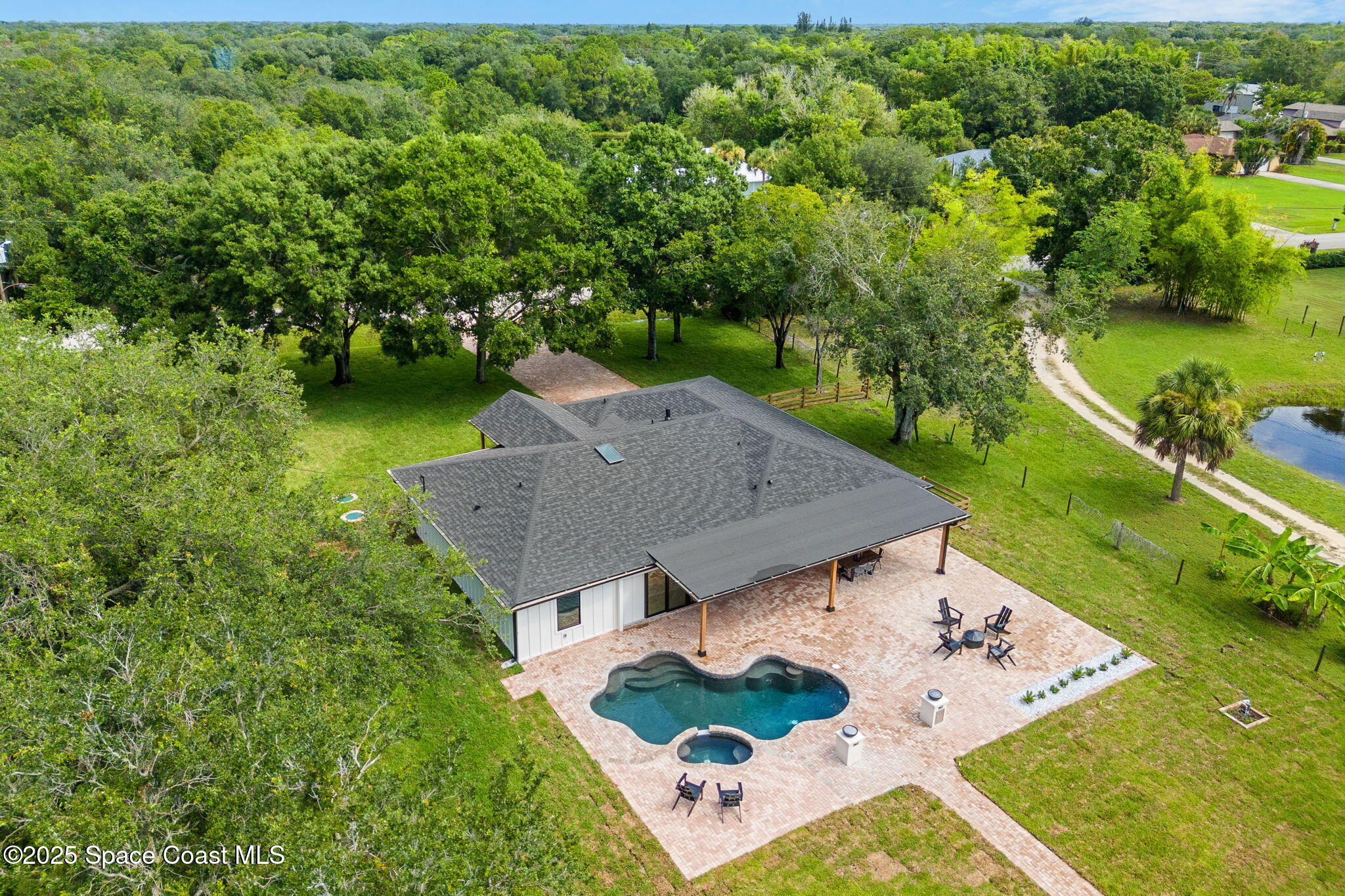 4313 Country Road Melbourne, FL 32934 - Photo 31 of 58 an aerial view of a house with yard swimming pool and outdoor seating
