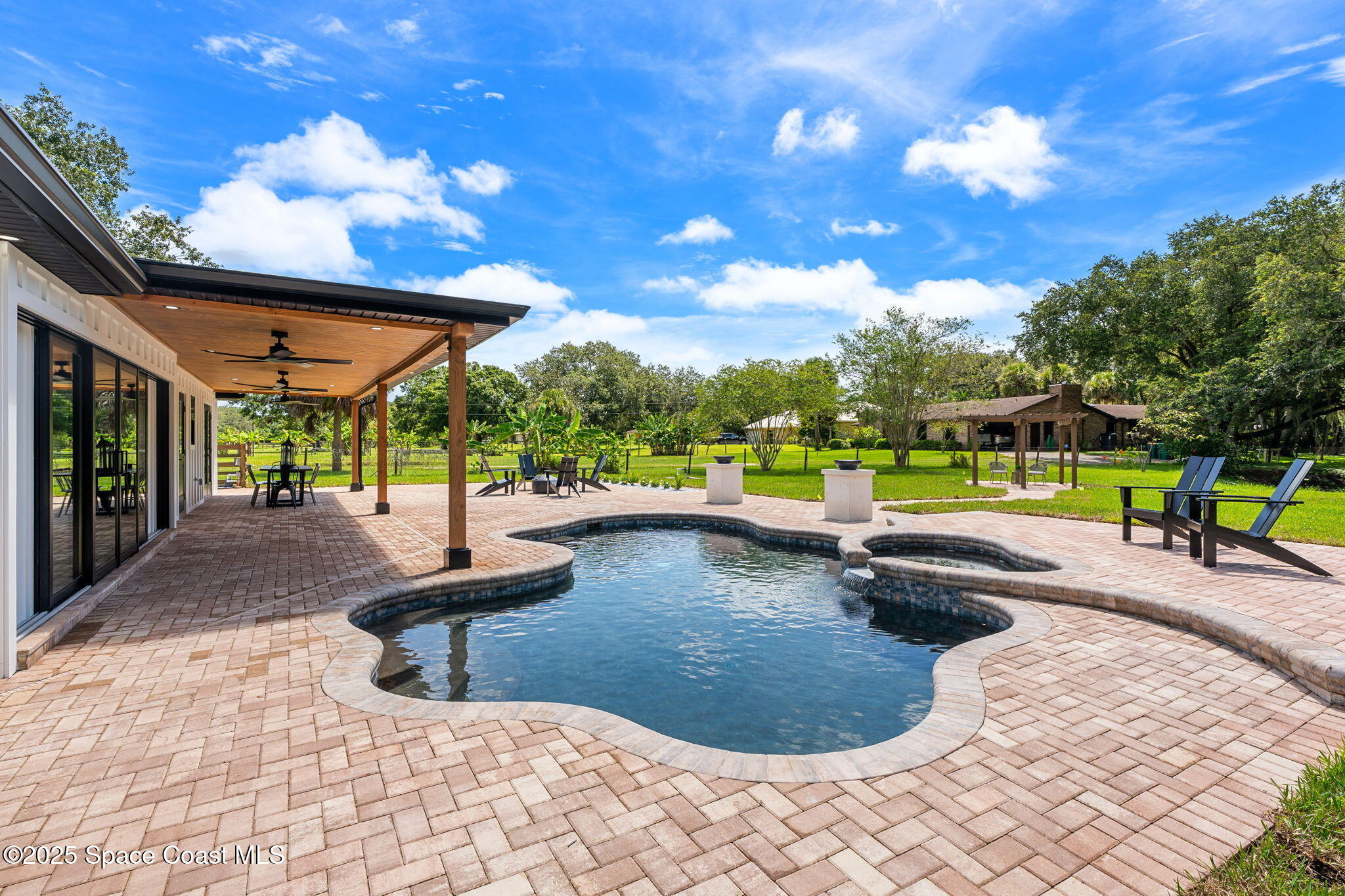 4313 Country Road Melbourne, FL 32934 - Photo 34 of 58 a view of a swimming pool with a patio