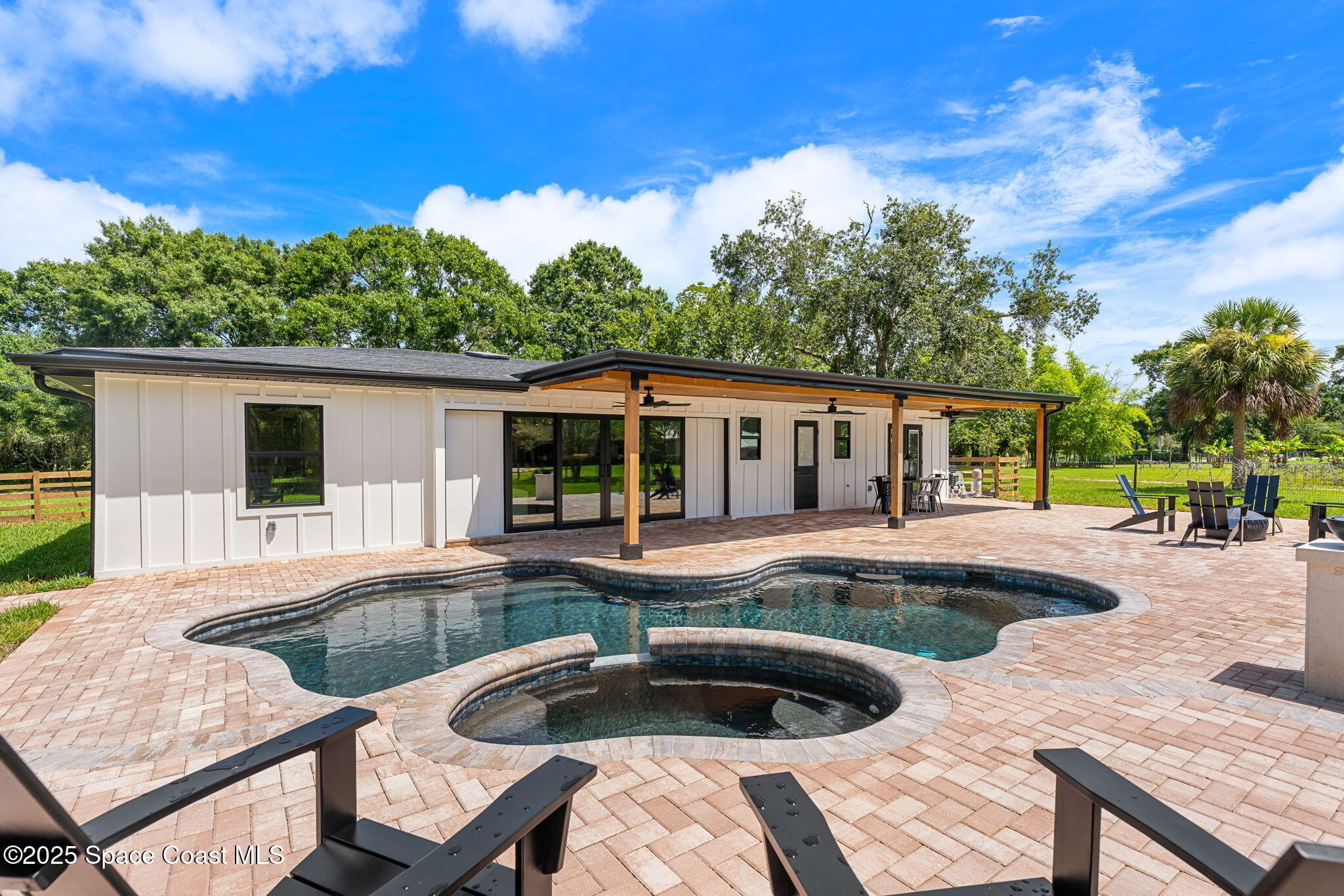4313 Country Road Melbourne, FL 32934 - Photo 35 of 58 a view of a house with swimming pool and sitting area