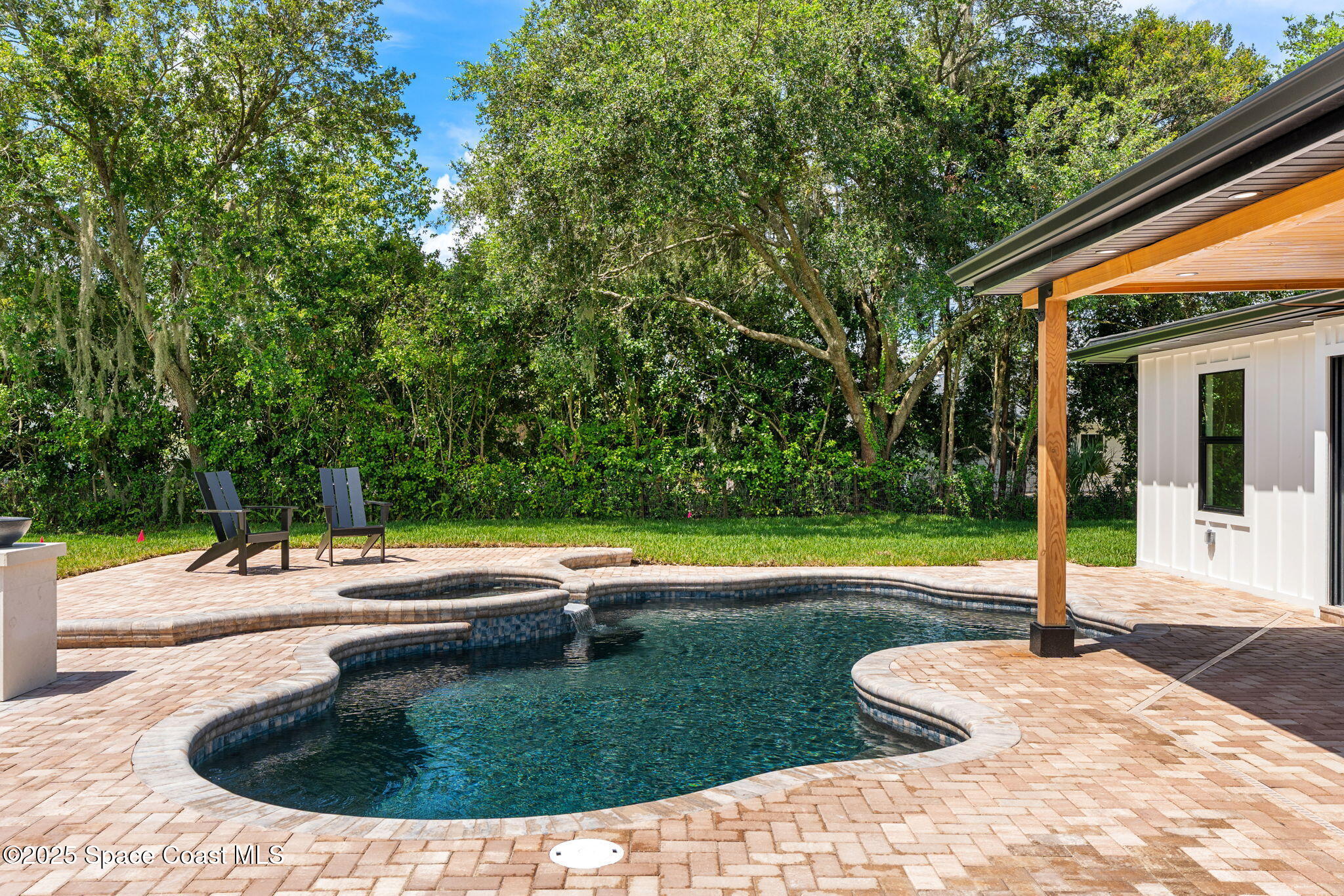 4313 Country Road Melbourne, FL 32934 - Photo 36 of 58 a view of a swimming pool with a sitting space