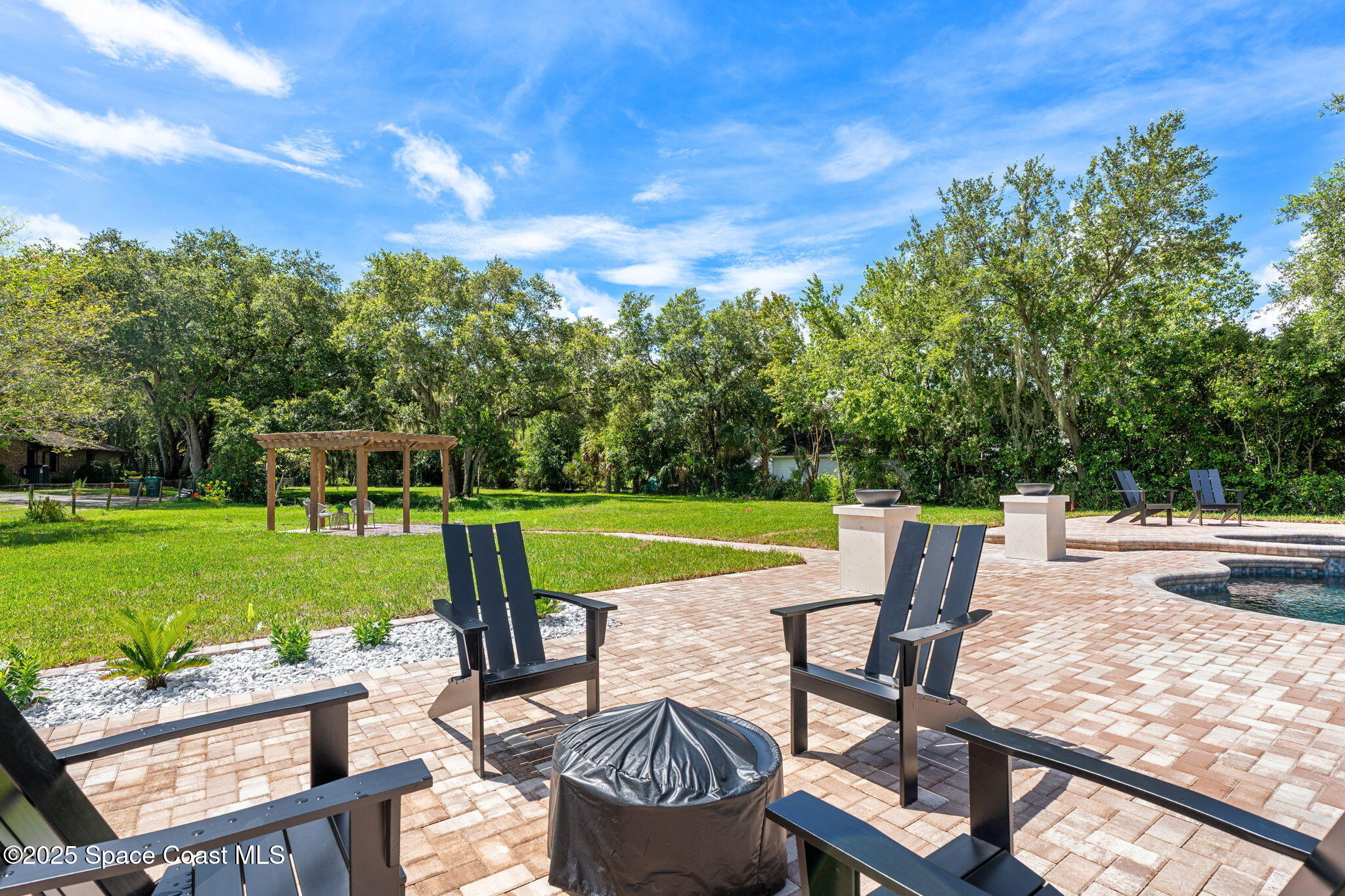 4313 Country Road Melbourne, FL 32934 - Photo 37 of 58 a view of a chairs and table in the yard