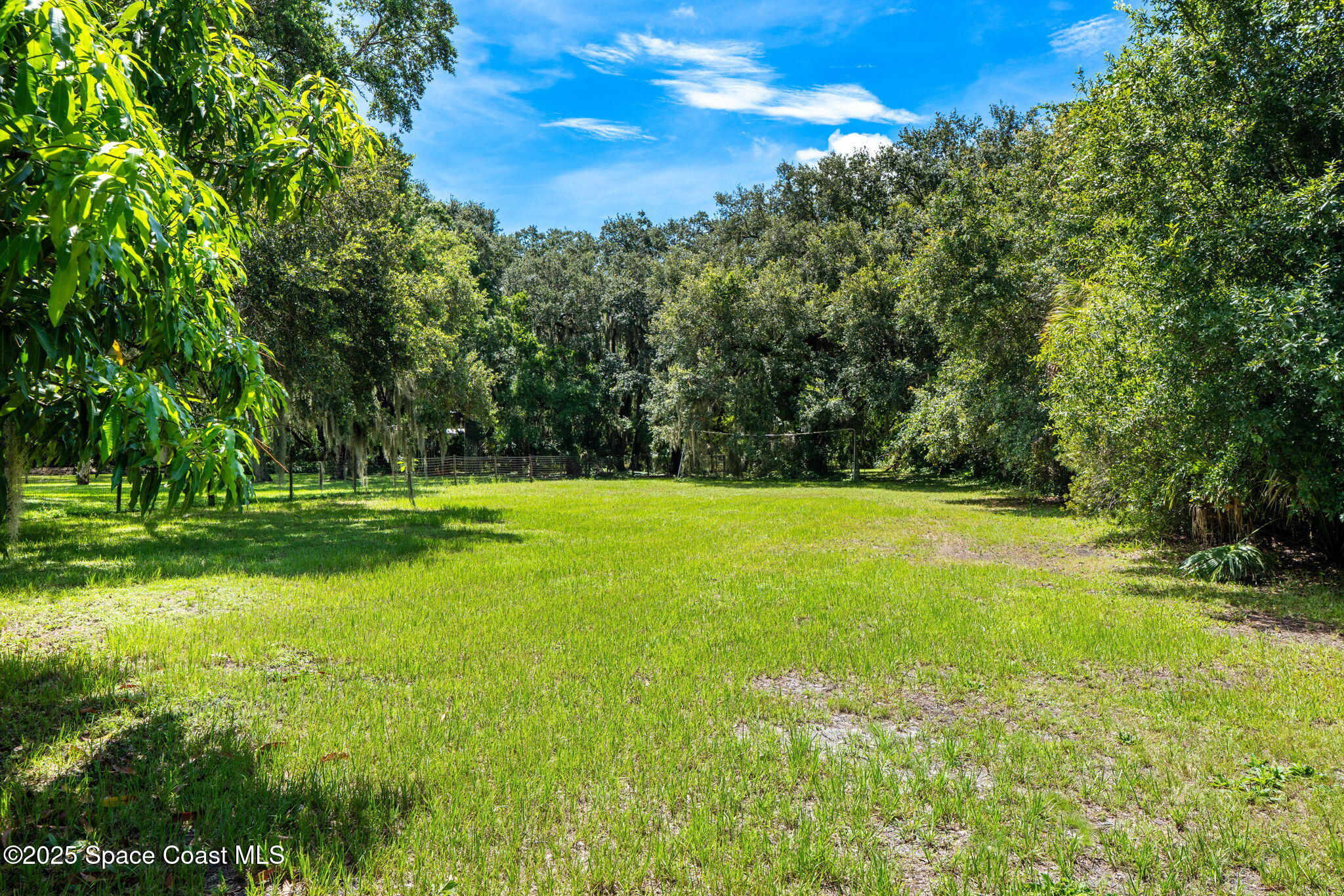 4313 Country Road Melbourne, FL 32934 - Photo 43 of 58 a view of a golf course with a yard