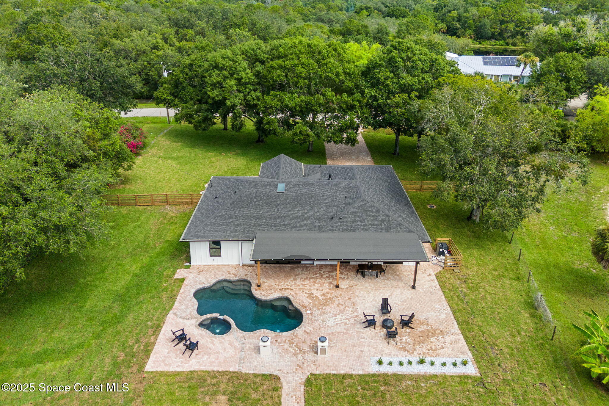 4313 Country Road Melbourne, FL 32934 - Photo 45 of 58 an aerial view of a house with swimming pool and garden