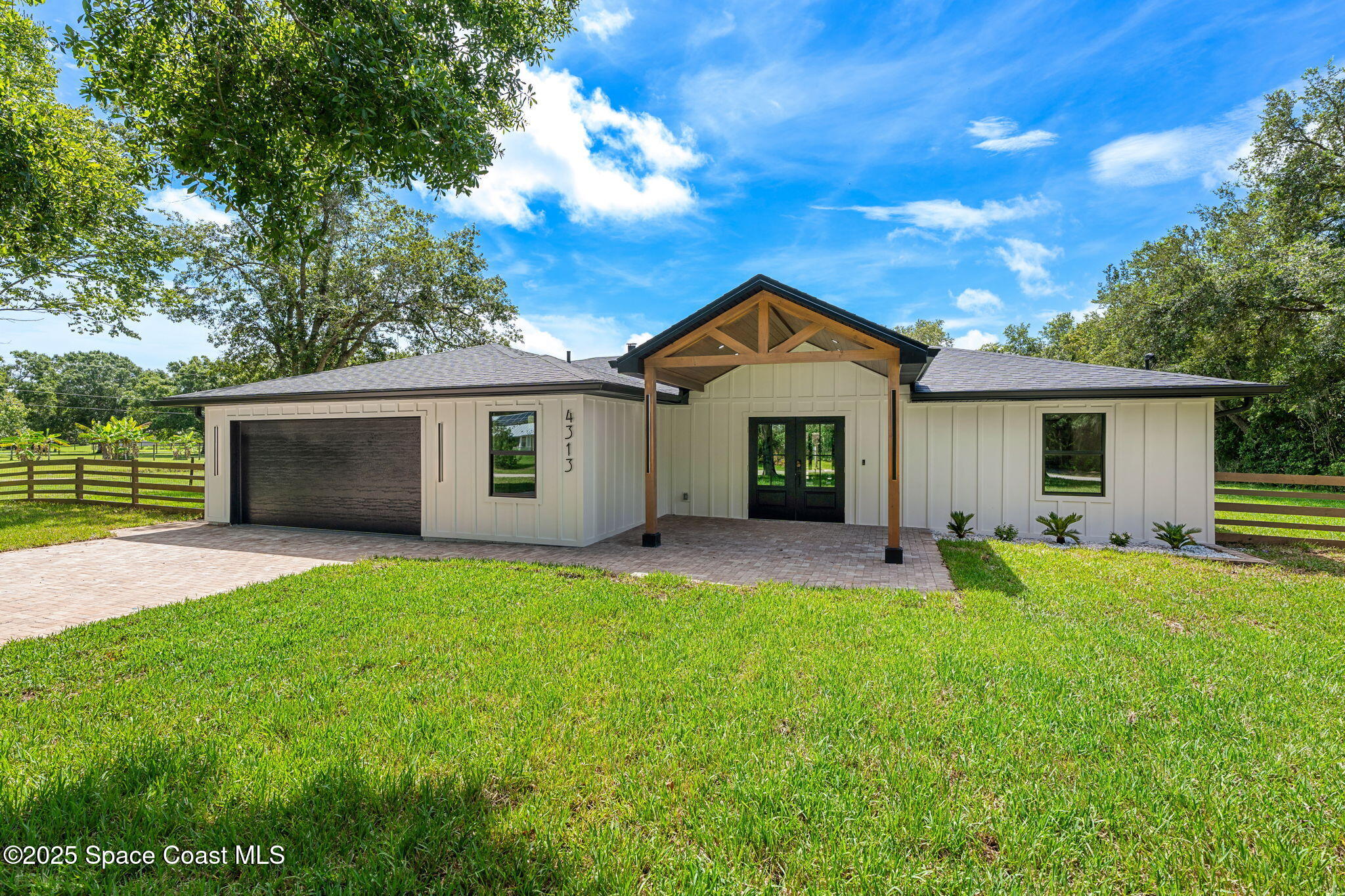 4313 Country Road Melbourne, FL 32934 - Photo 47 of 58 front view of a house with a yard