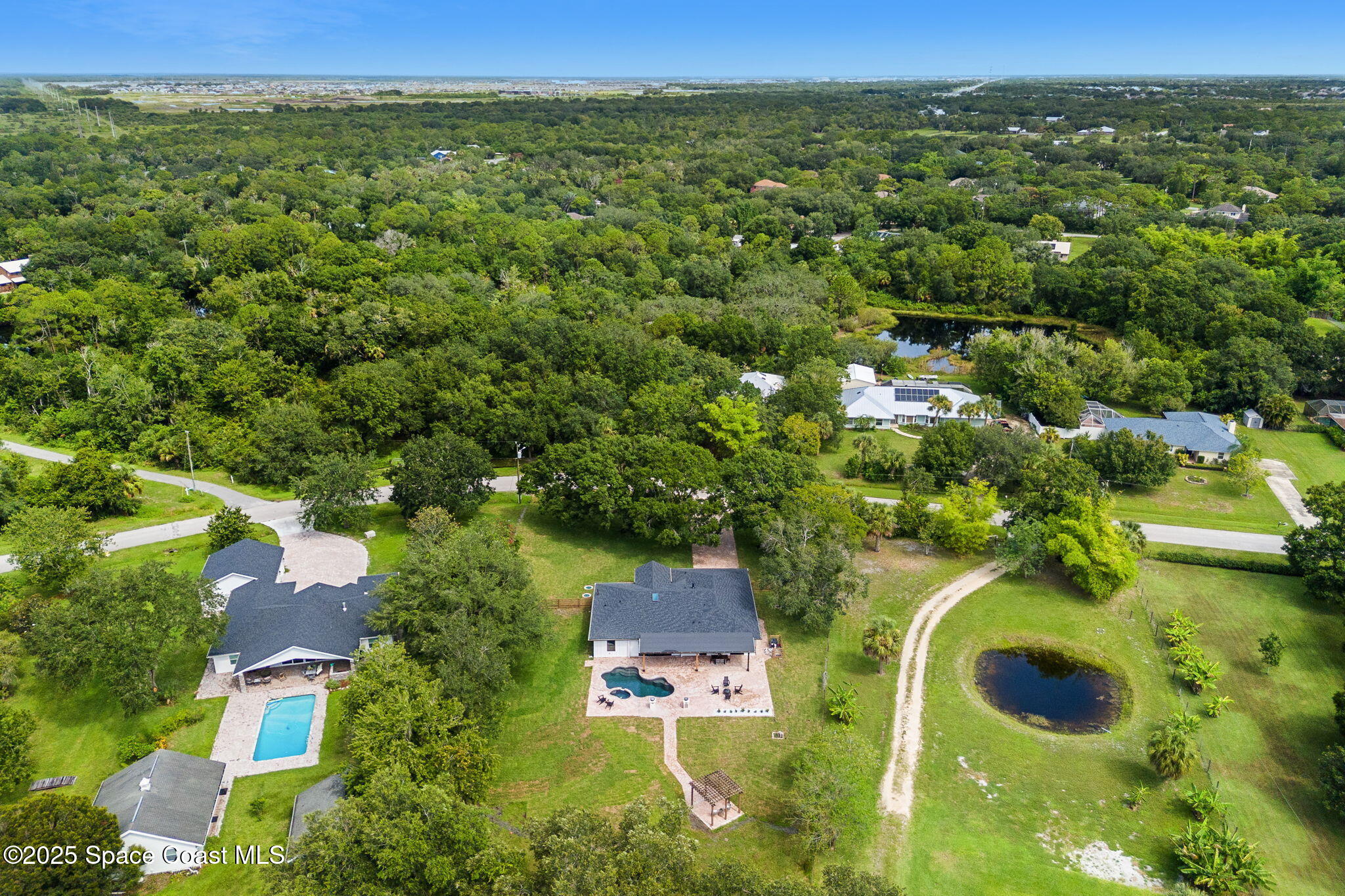 4313 Country Road Melbourne, FL 32934 - Photo 52 of 58 an aerial view of residential houses with outdoor space