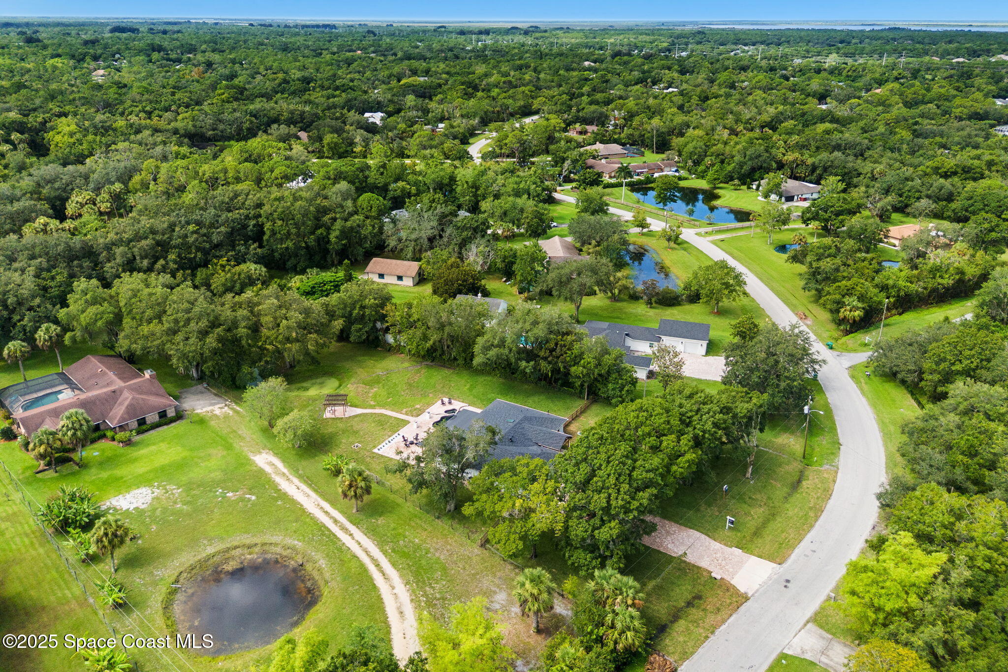 4313 Country Road Melbourne, FL 32934 - Photo 54 of 58 an aerial view of residential houses with outdoor space and street view
