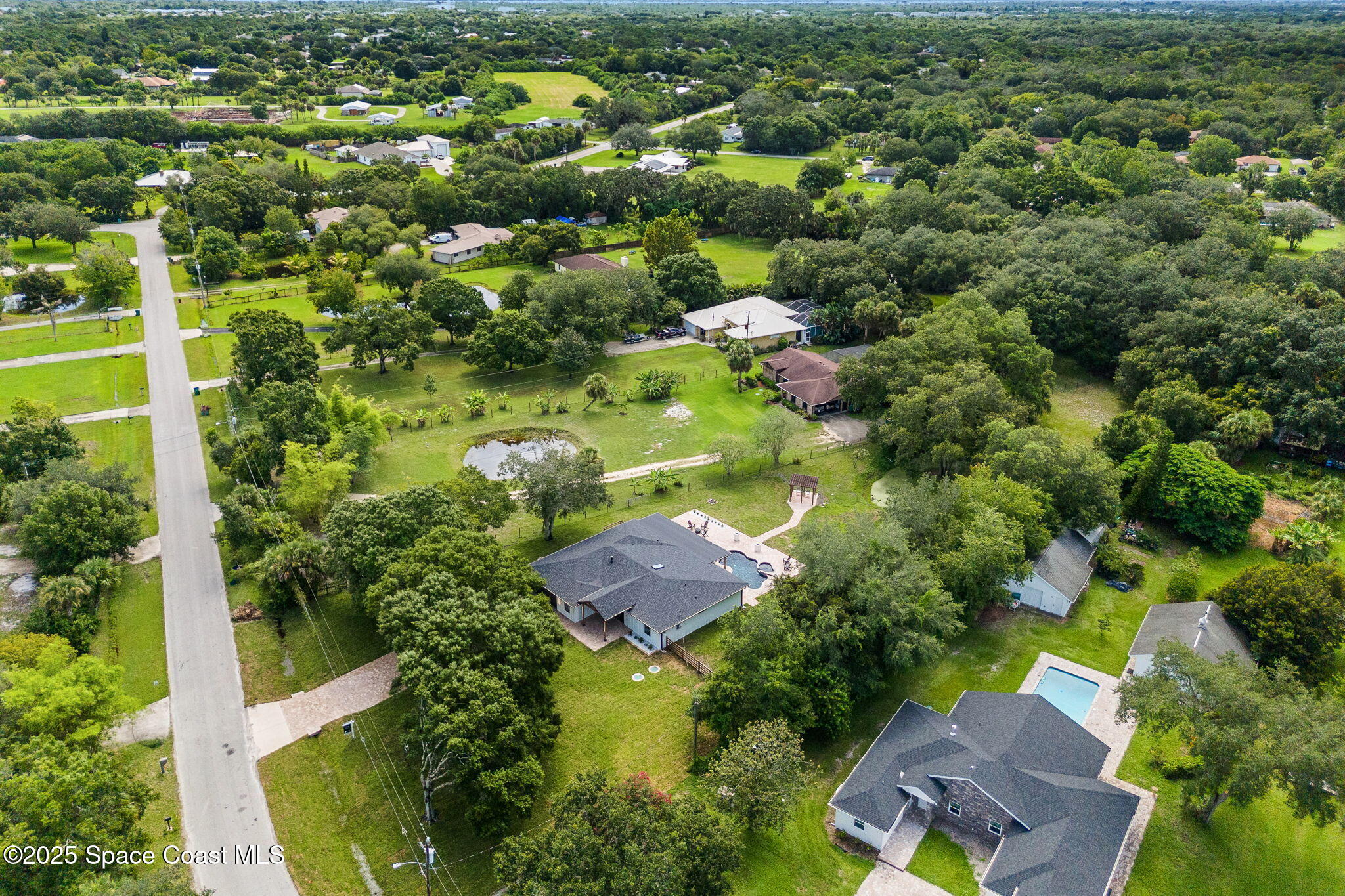 4313 Country Road Melbourne, FL 32934 - Photo 55 of 58 an aerial view of residential house with outdoor space and swimming pool