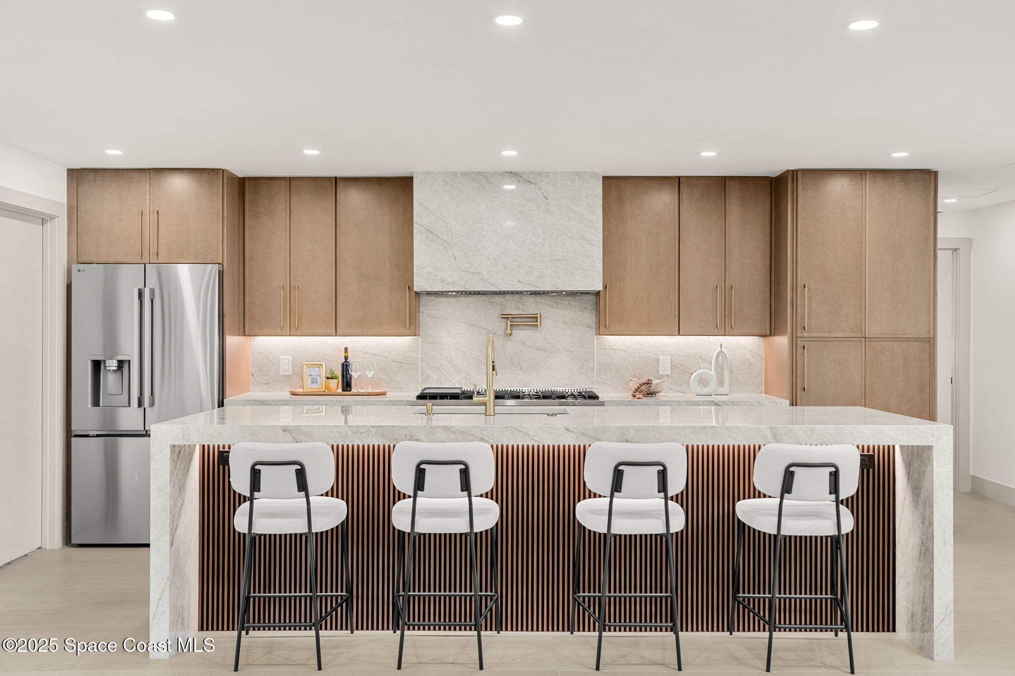 4313 Country Road Melbourne, FL 32934 - Photo 10 of 58 a kitchen with a dining table chairs refrigerator and cabinets