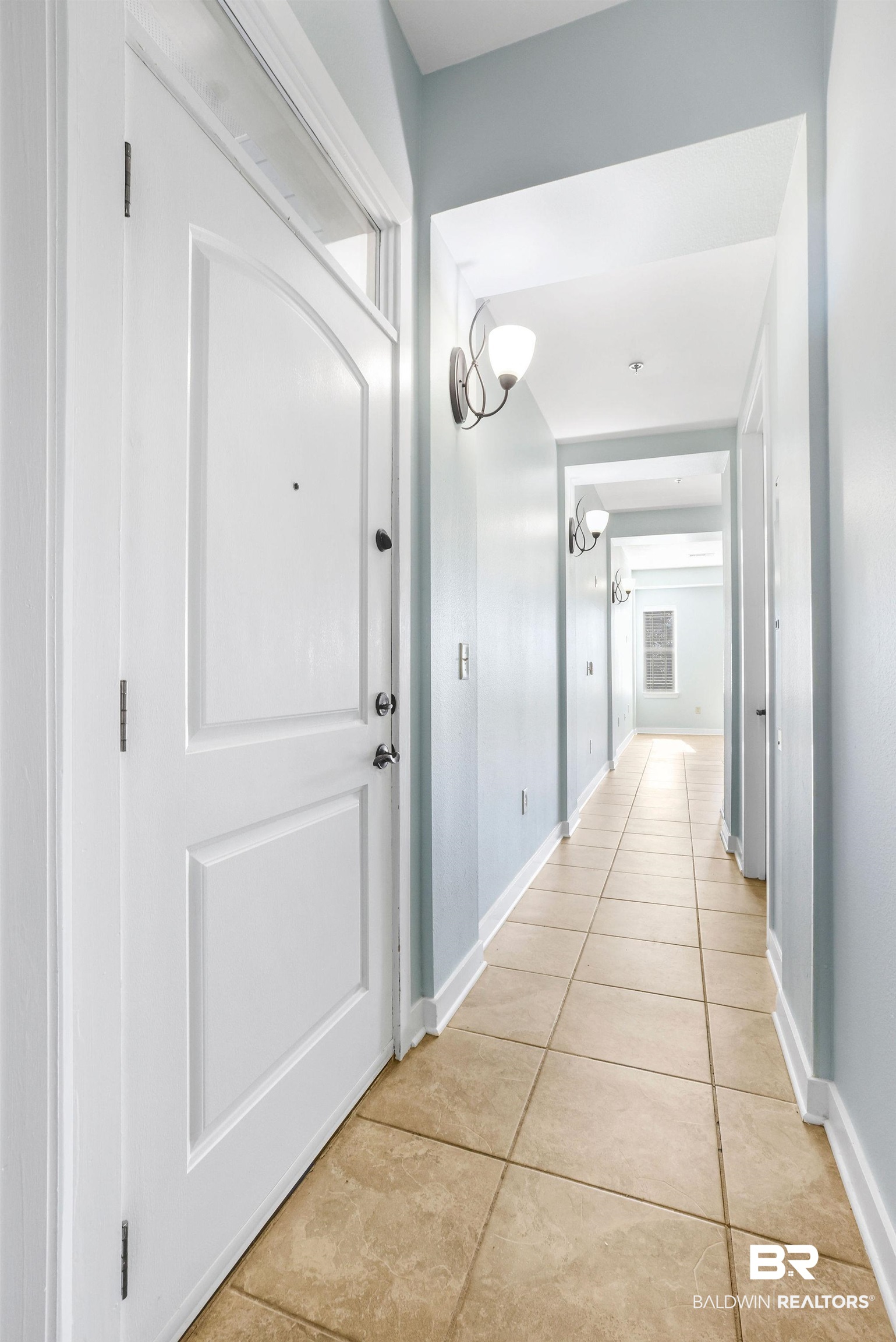 1430 Regency Road, Unit B302 Gulf Shores, AL 36542 - Photo 18 of 24 Hallway featuring light tile patterned flooring and baseboards