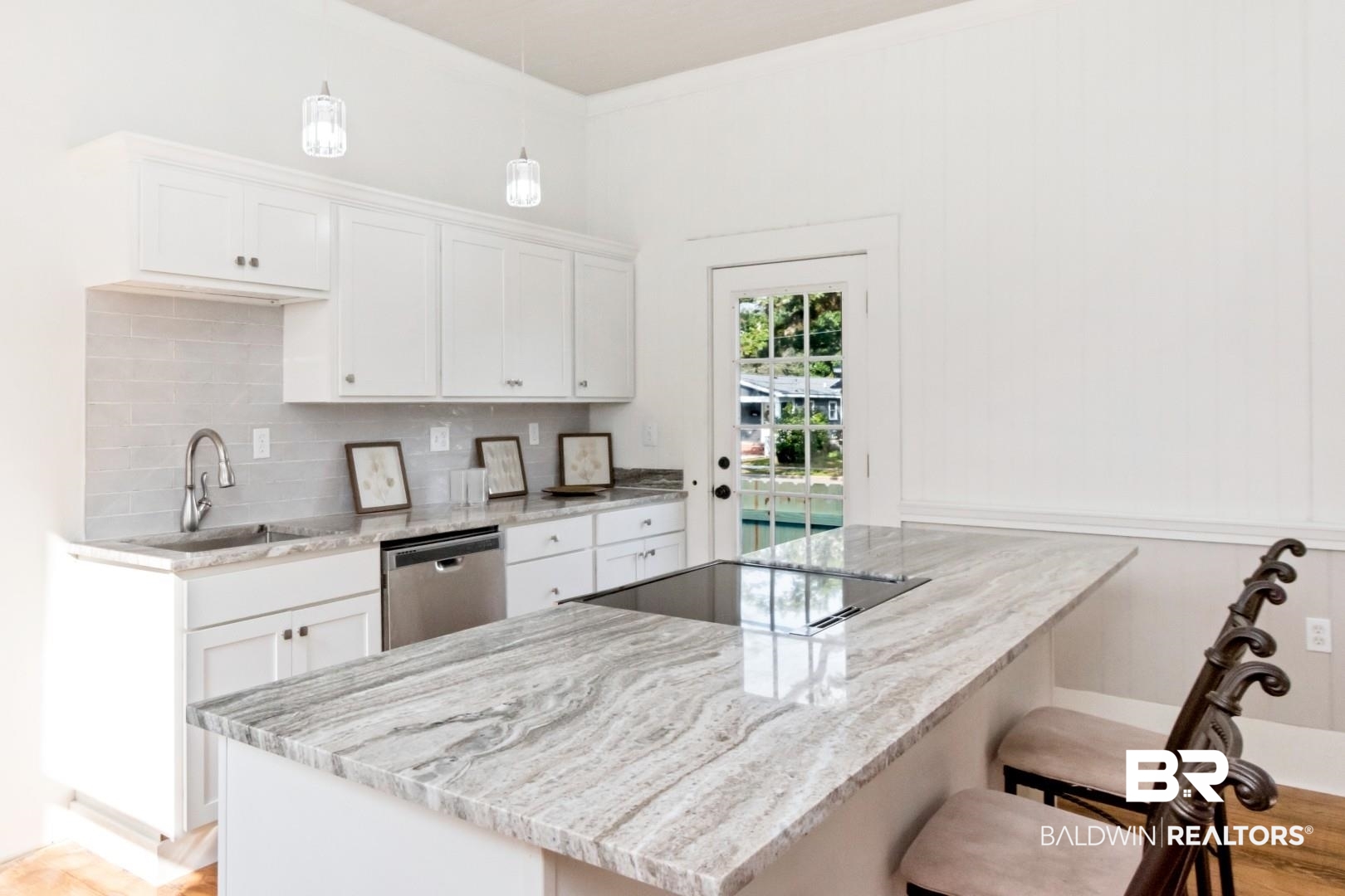 352 Marine Street Mobile, AL 36604 - Photo 6 of 20 Kitchen featuring light stone countertops, white cabinetry, a peninsula, dishwasher, and a kitchen bar