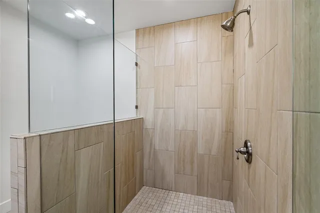 a bathroom with a shower and a shower