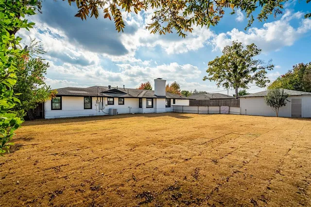a swimming pool with trees in the background